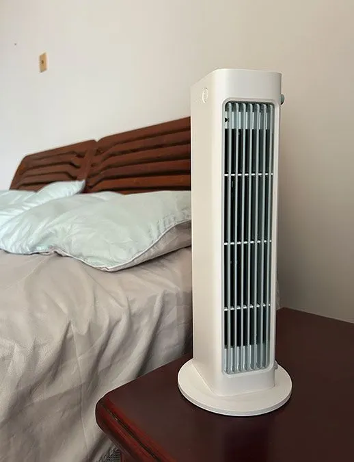 BreezaMax is on a table alongside the Bed